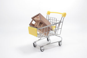 Miniature house, shopping cart , buying new house,